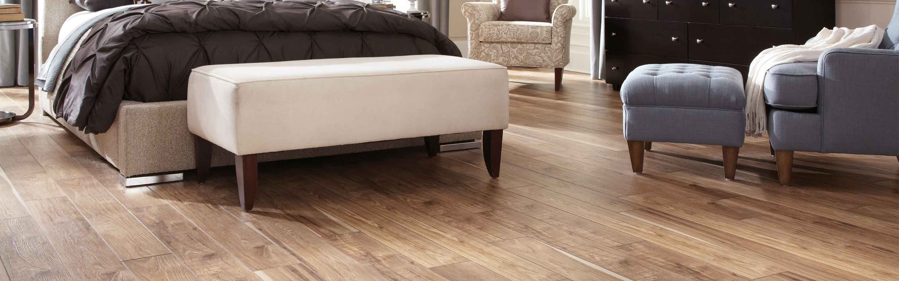 honey hued wood look laminate flooring in cosy bedroom